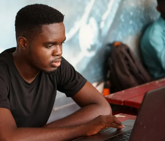 Student working on a laptop in a university library